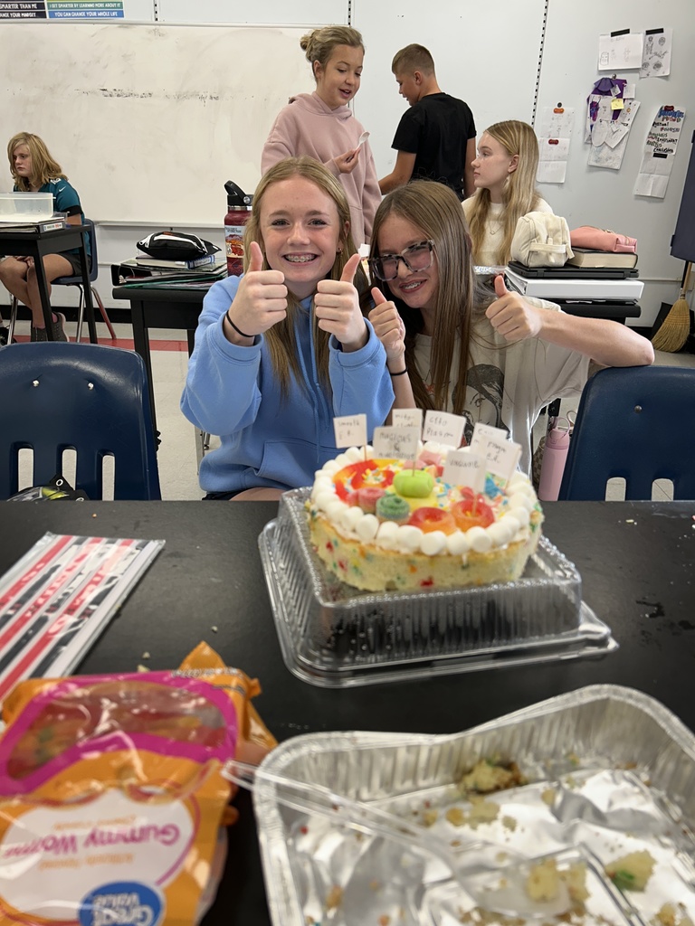 Students display their edible cell project.
