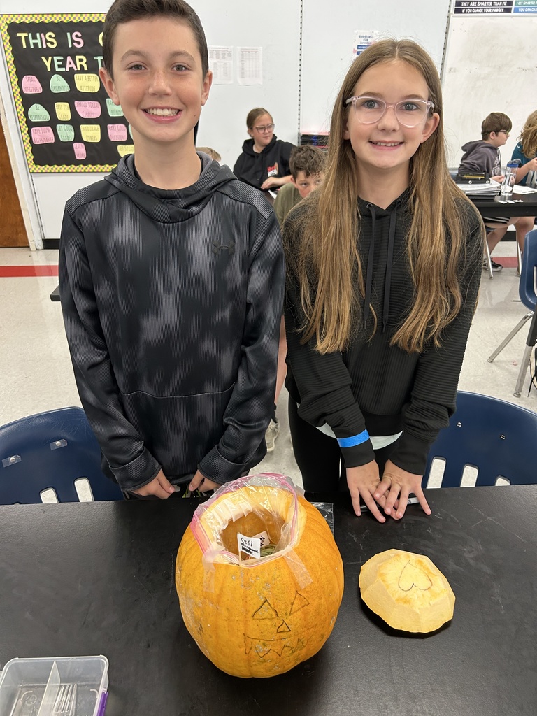 Students display their edible cell project.