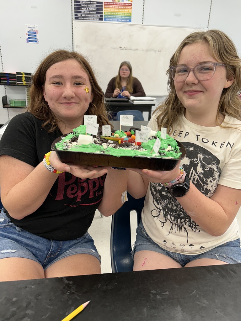 Students display their edible cell project.