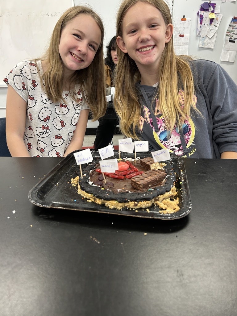 Students display their edible cell project.