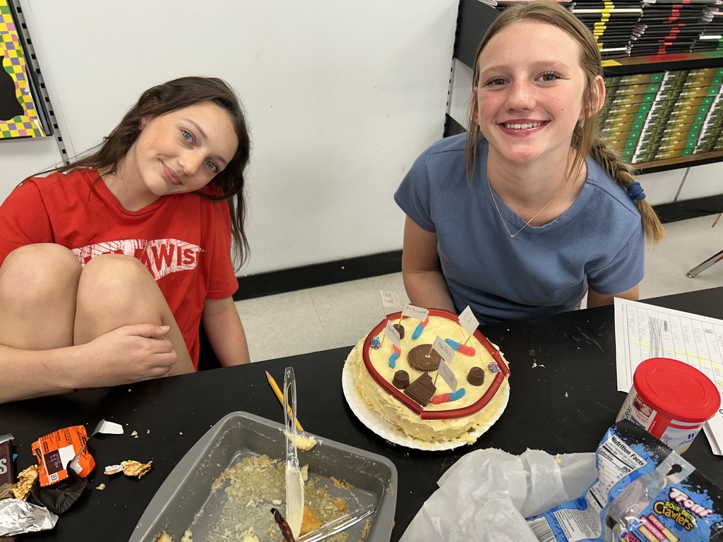 Students display their edible cell project.