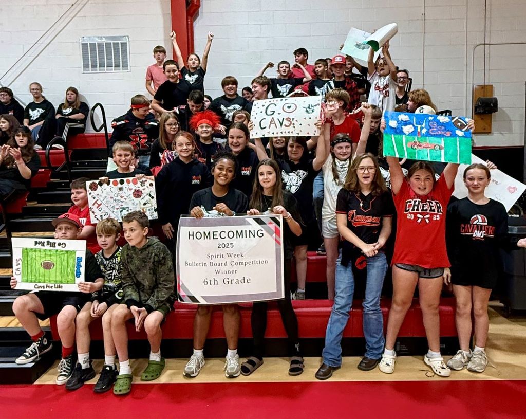 Students cheer in a gym.
