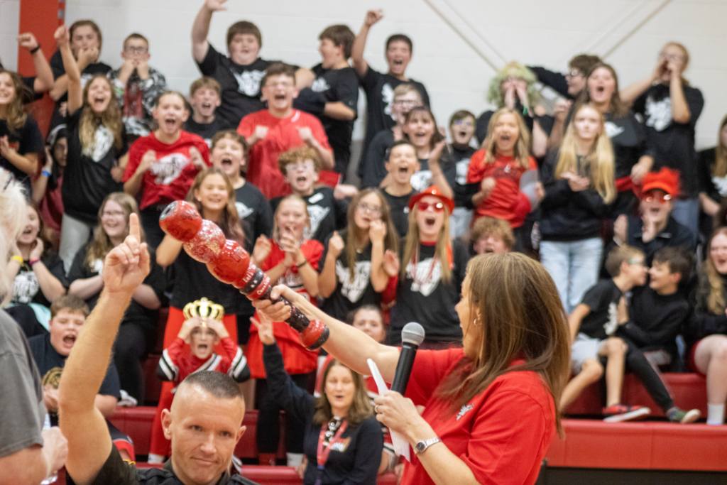 Students cheer in a gym.