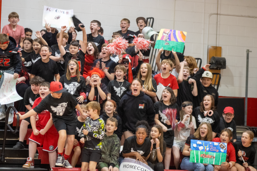 Students cheer in a gym.
