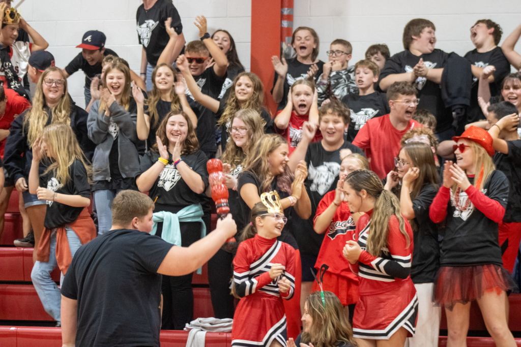 Students cheer in a gym.