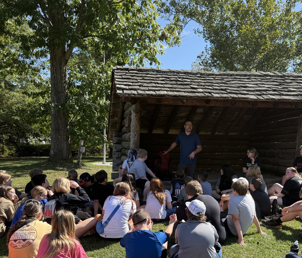 A man talks to students about packing a backpack.