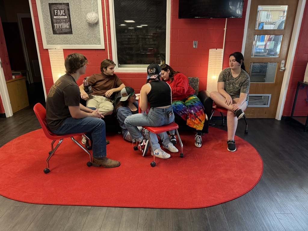 Students work on a video in a library.