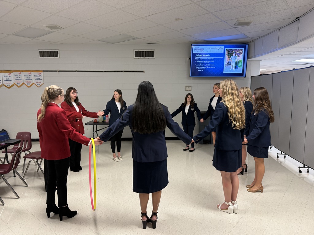 Students play a game with a hula hoop.