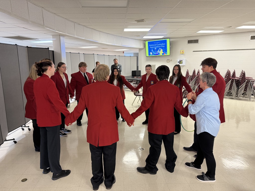 Students play a game with a hula hoop.