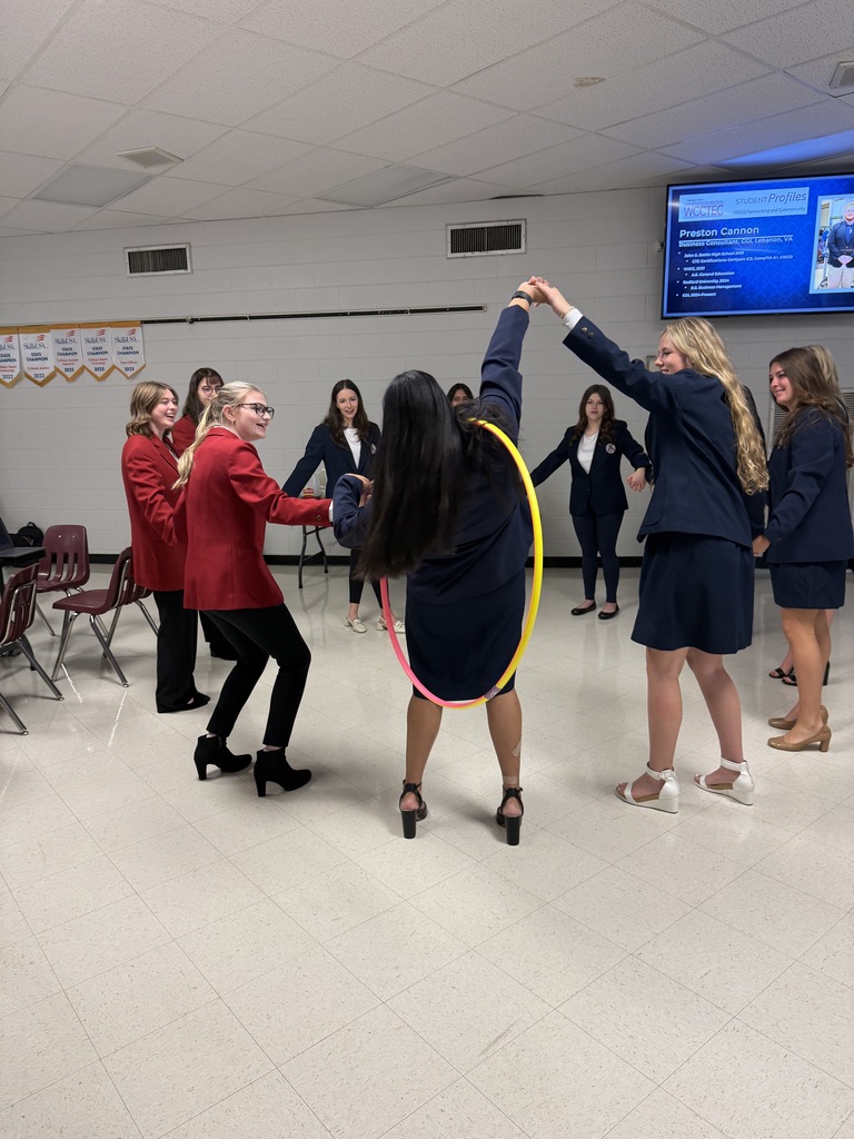 Students play a game with a hula hoop.