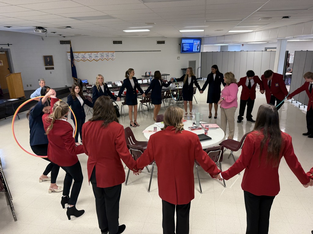 Students play a game with a hula hoop.