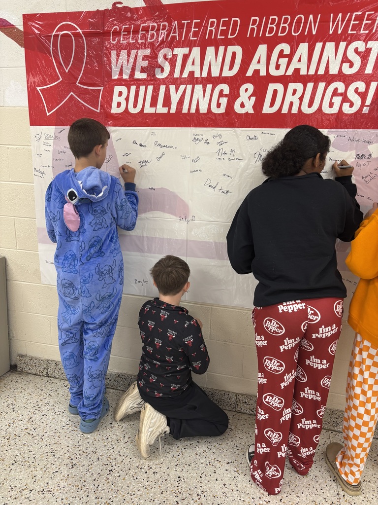 Students sign the anti-bullying sign.