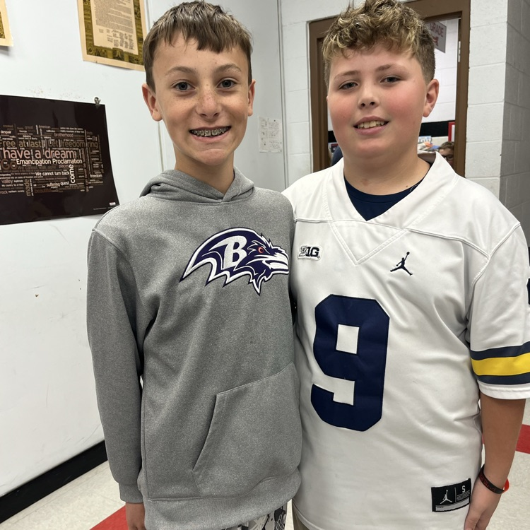 Students pose in team jerseys.