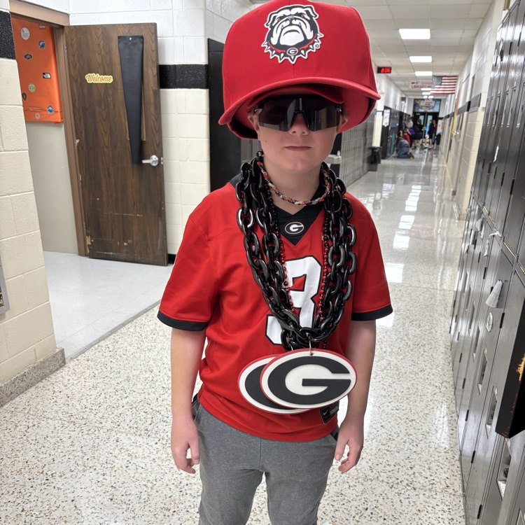 A student poses in a team jersey and gear.