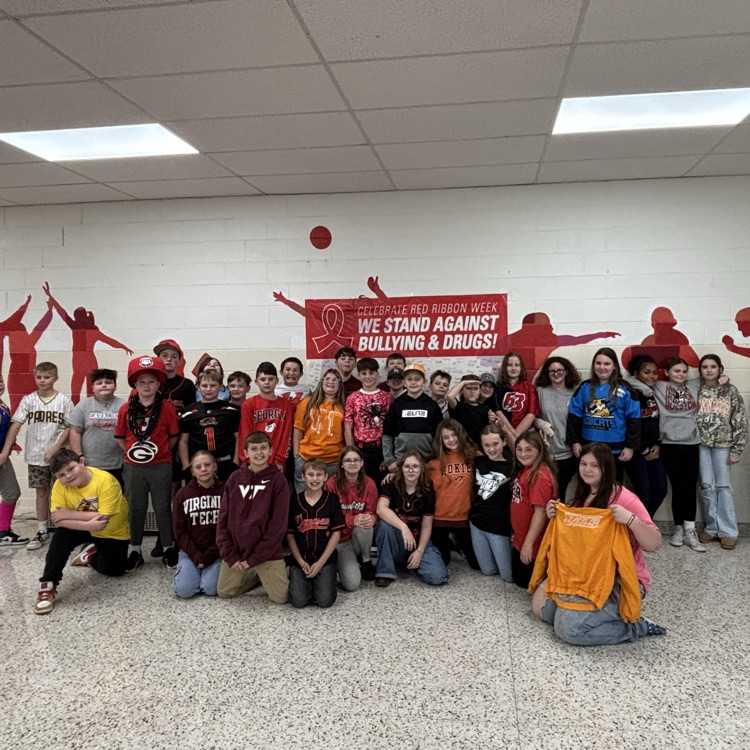 Students pose in team jerseys.