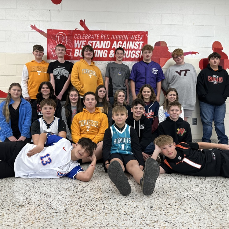 Students pose in team jerseys.