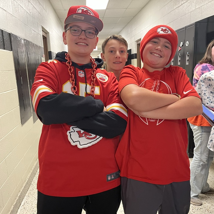 Students pose in team jerseys.