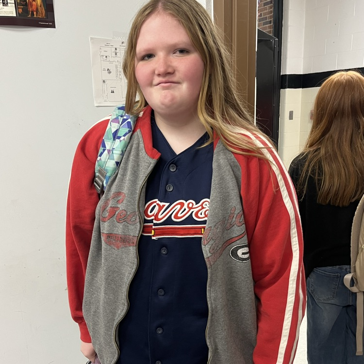 A student poses in a team jersey.