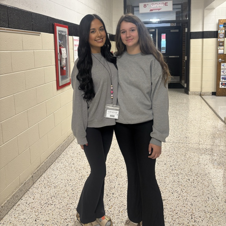 A teacher and a student are dressed alike.