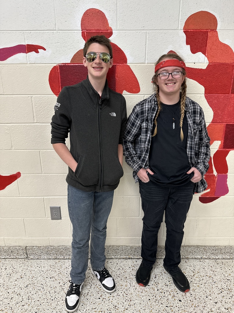Two students pose in Halloween costumes.