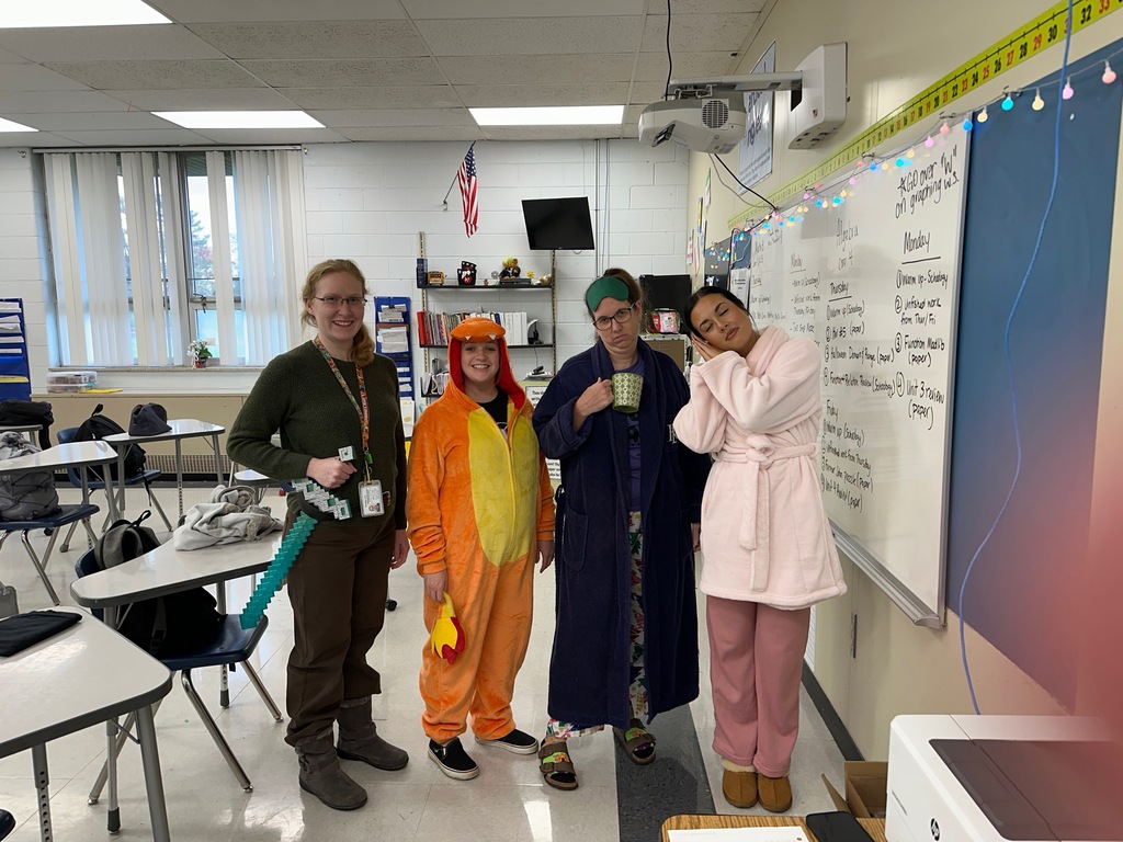 Teachers pose in Halloween costumes.