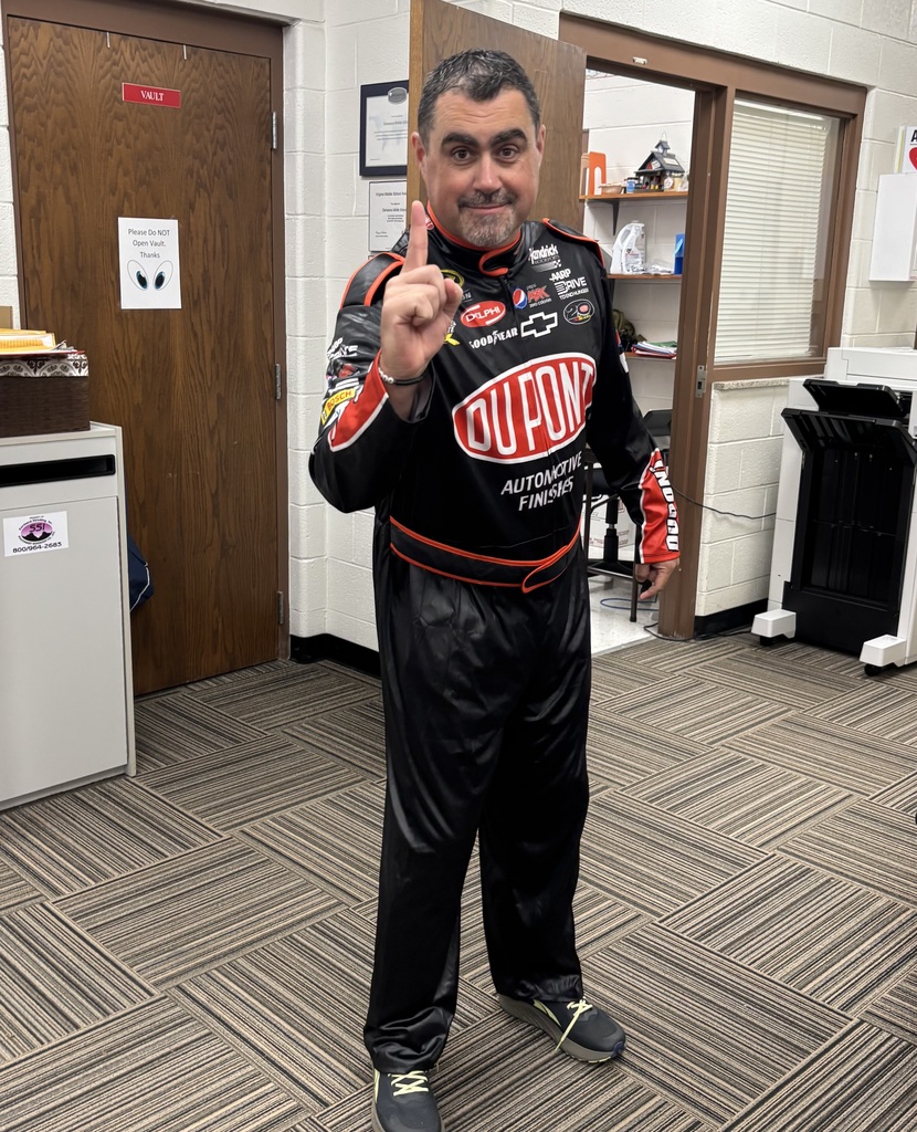 A man poses in a racing uniform.