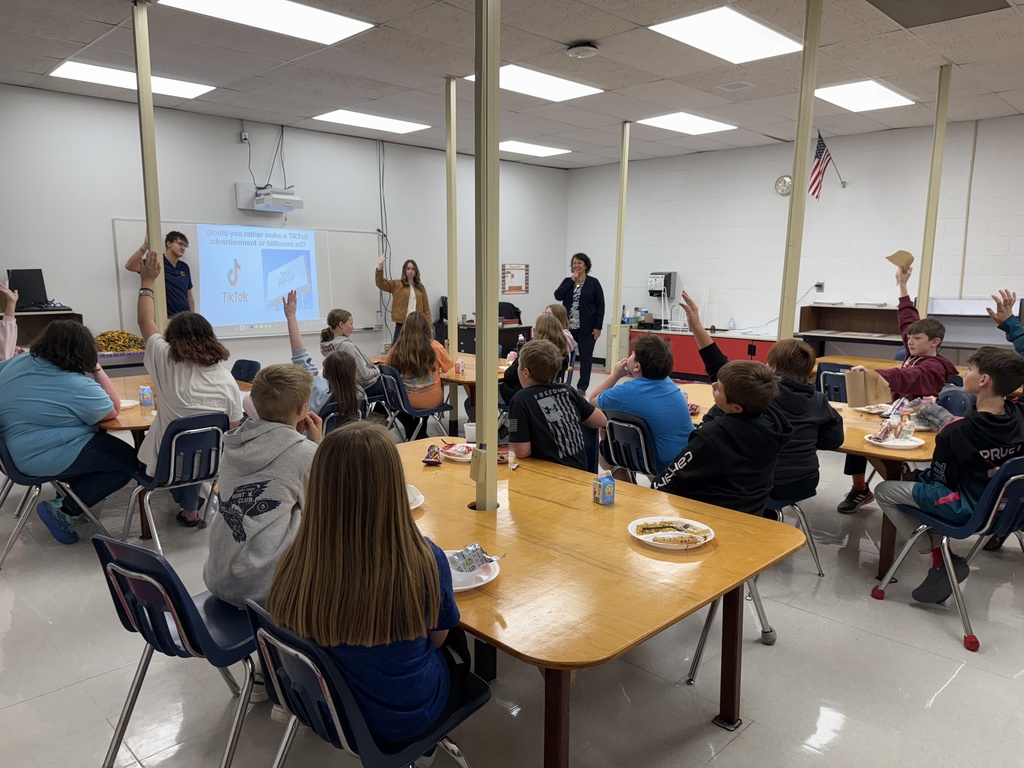 Students listen to three adults talk about fashion merchandising.
