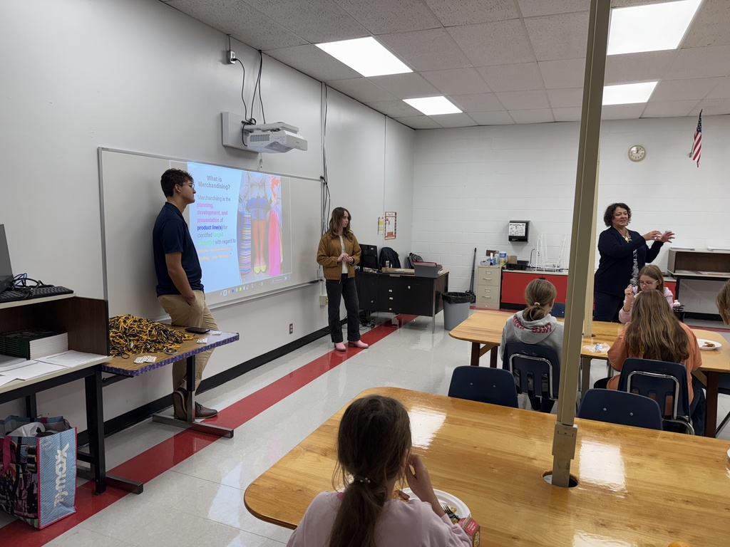 Students listen to three adults talk about fashion merchandising.