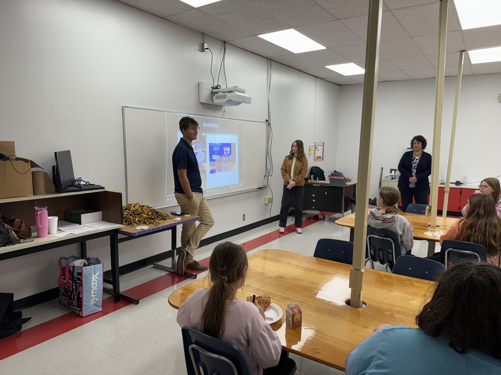 A man talks to a group of students.