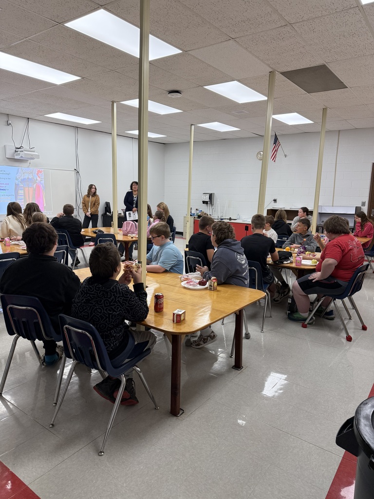 Students listen to three adults talk about fashion merchandising.