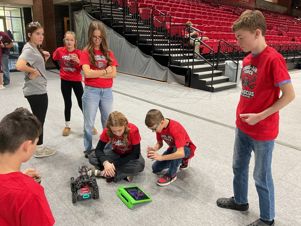 Robotics students work together.