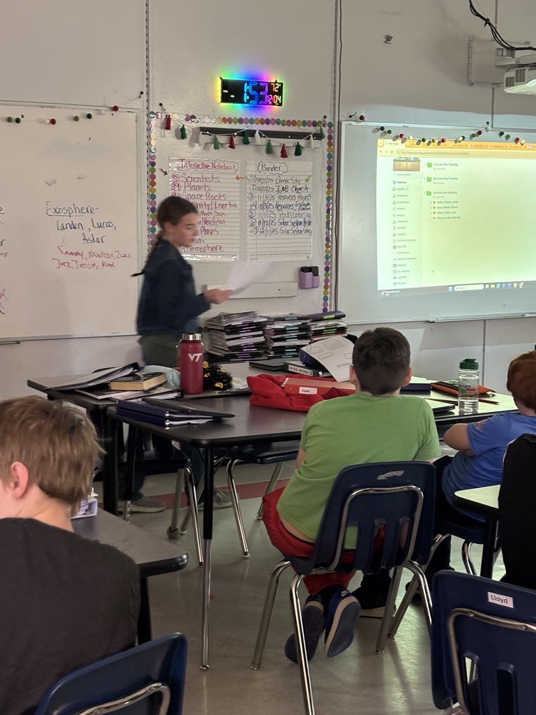 Students teach their classmates in a classroom.