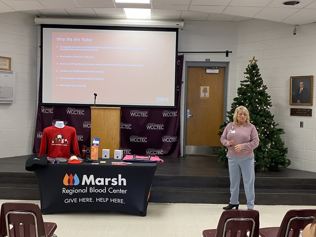 A woman presents information about blood donation.