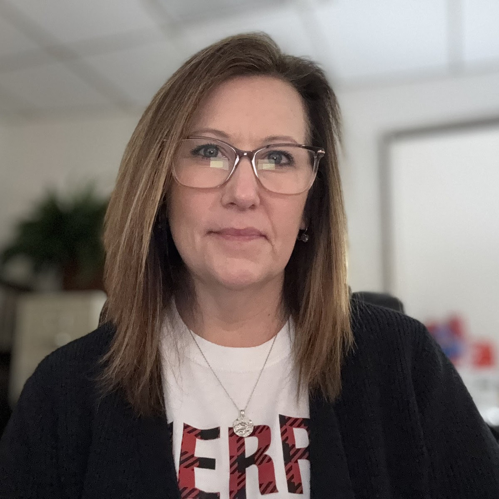 A woman smiles at the camera.