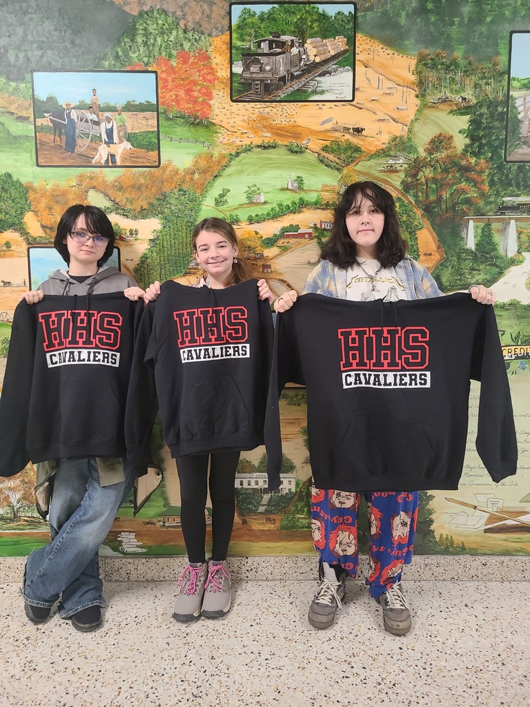 Three students pose with new hoodies.