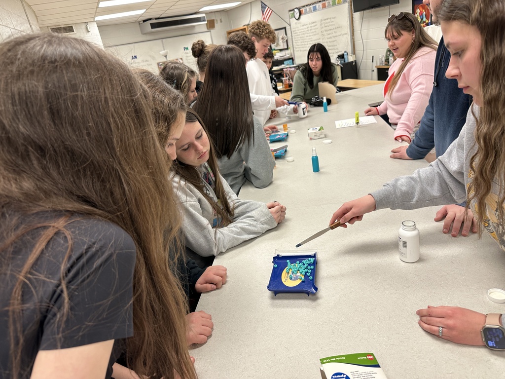 Students practice counting pills in a Pharmacy shop.