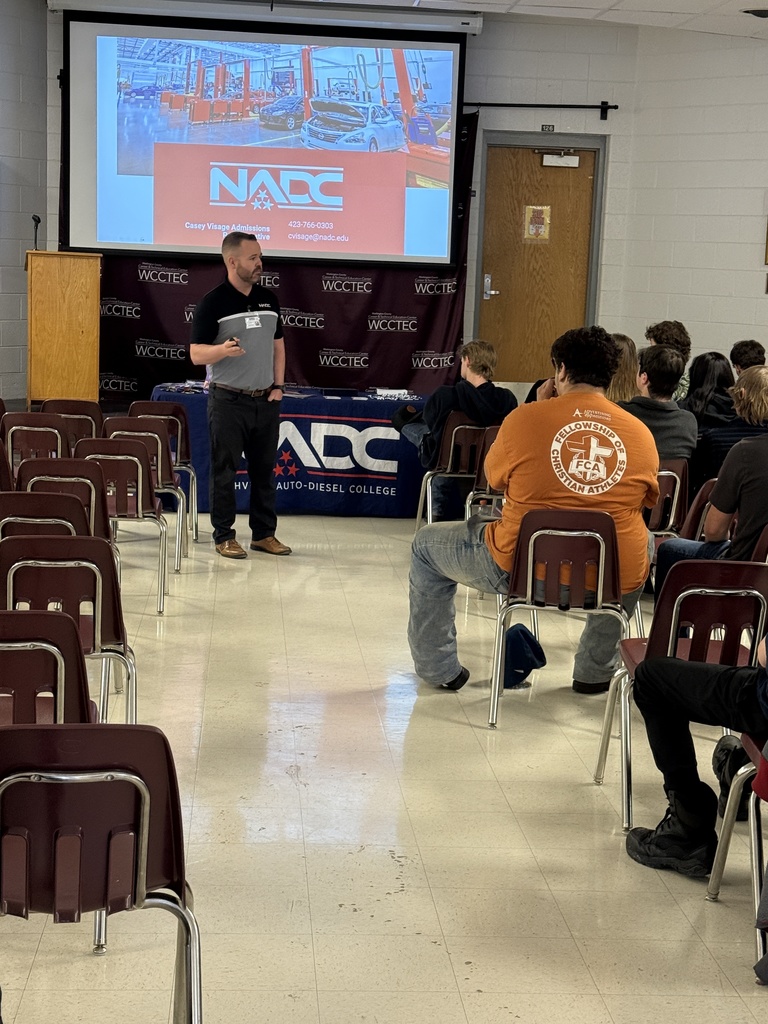 A man talks with students in an auditorium.