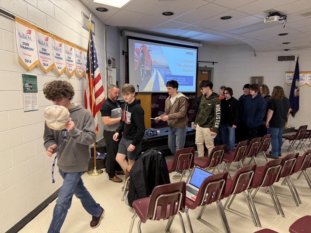 A man talks with students in an auditorium.