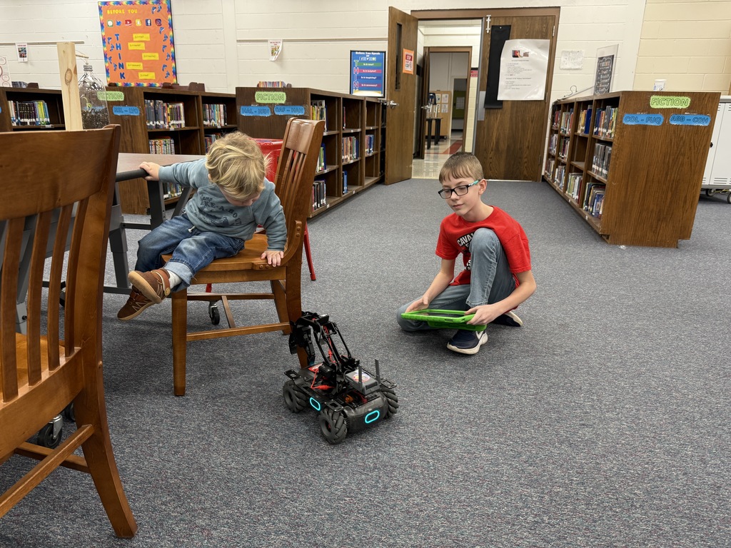 A student demonstrates a robot.