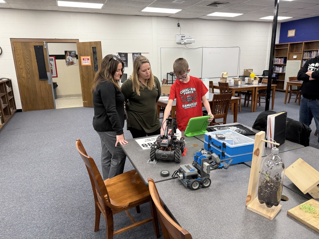 A student demonstrates a robot.