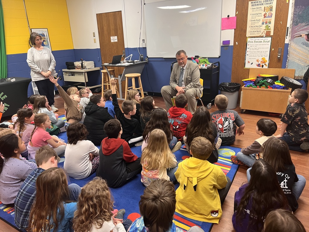 man reading to students
