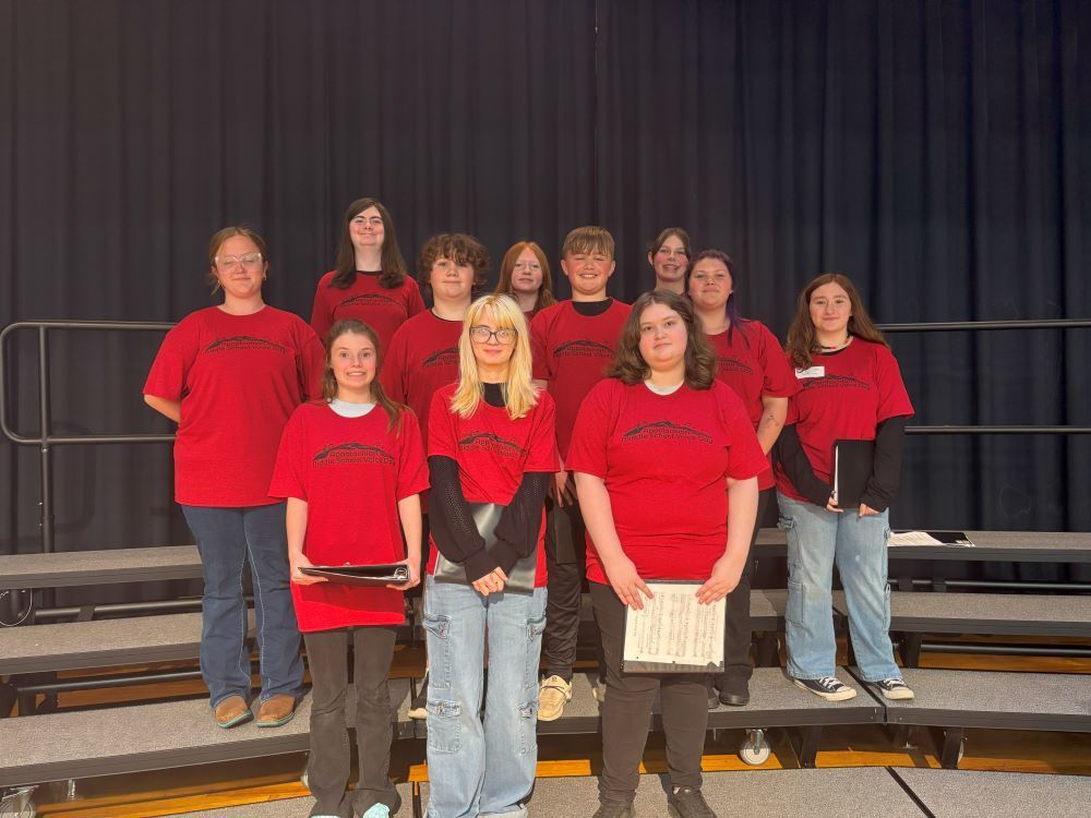 A group of students pose on a stage.