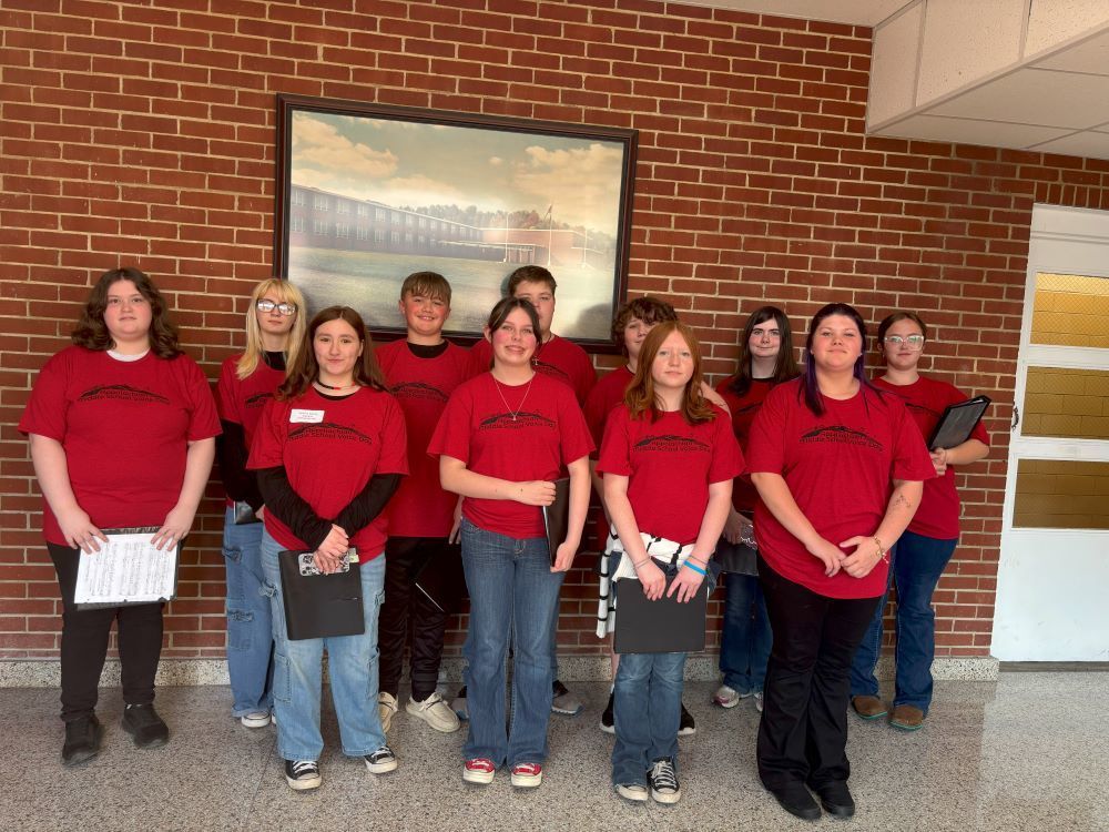 A group of students pose in a hallway.