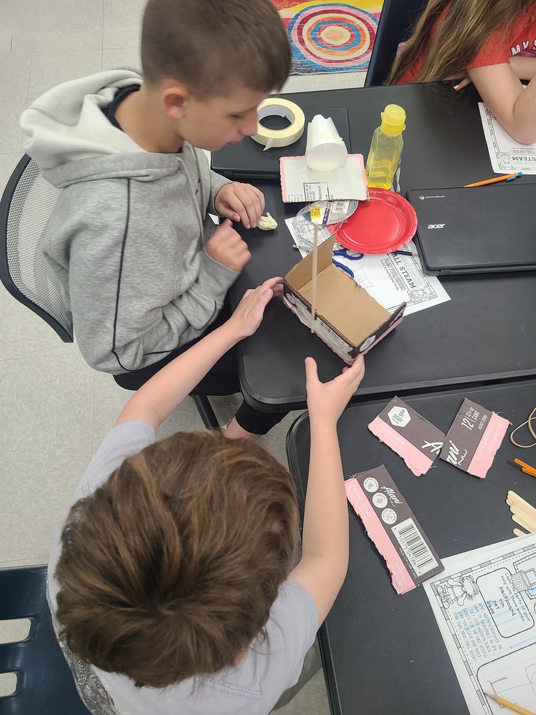 Students build a basketball hoop.