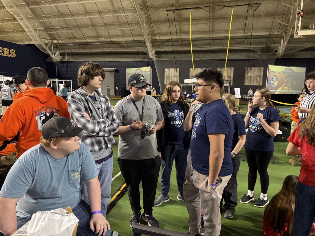 Students talk to another team at a Robotics competition.