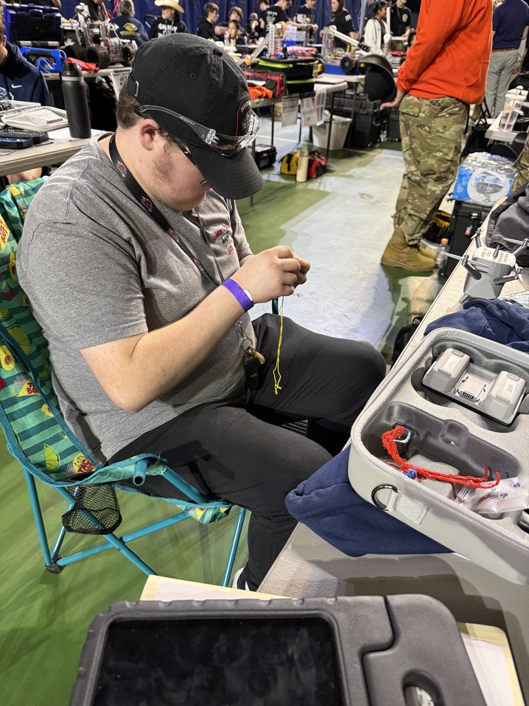 A student works on a drone accessory.