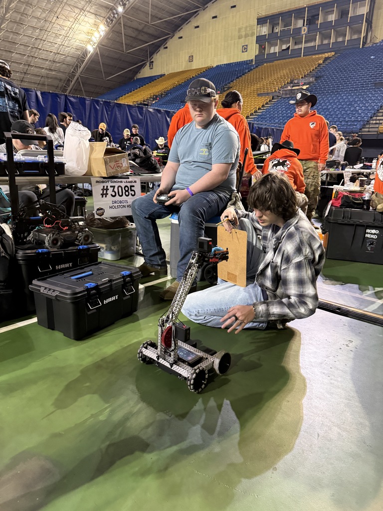 Students test a robot at a competition.