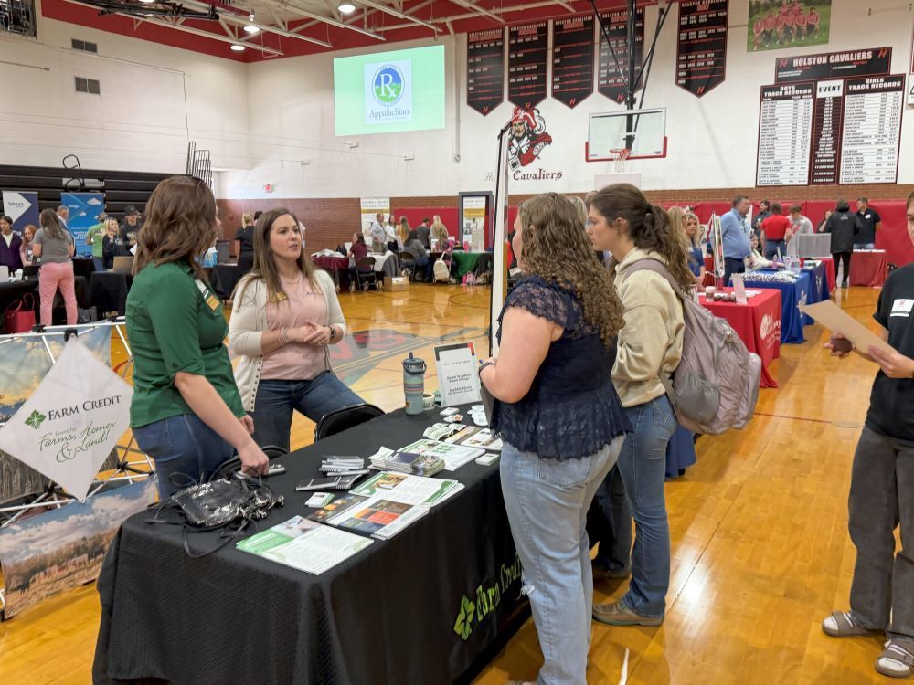 Two women talk with two students about careers in Agriculture.