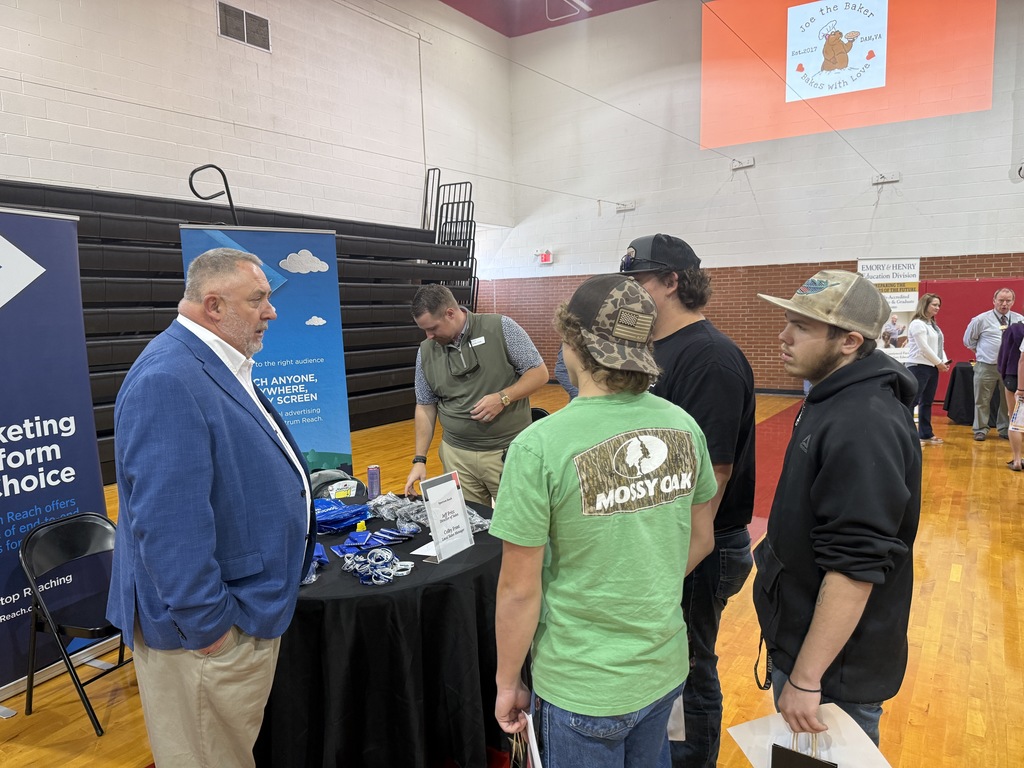 A man talks to students about his marketing career.