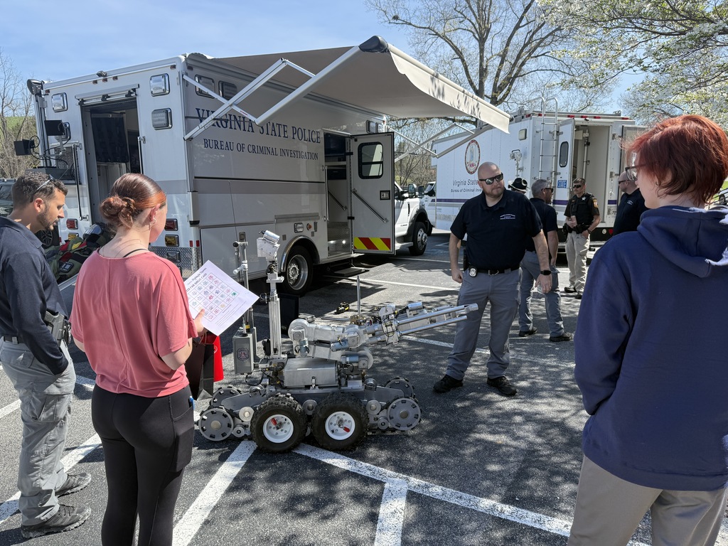 Two state policemen talk to students about their careers.